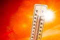 Bright Sun Shining In An Orange Sky Next To A Thermometer Royalty Free Stock Photo