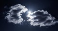 Bright Sun Shining Through Two Dark Dramatic Clouds in the Sky Royalty Free Stock Photo