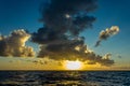 Bright sun at sunset or dawn over the water of the Pacific Royalty Free Stock Photo