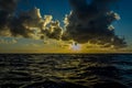 Bright sun at sunset or dawn over the water of the Pacific Royalty Free Stock Photo