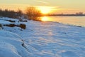 Bright sun at sunset in winter with large snow drifts. Evening, cool Royalty Free Stock Photo