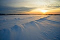 Bright sun sunset winter with road and footprints in the snow. Royalty Free Stock Photo