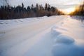 Bright sun sunset in winter snow-covered road . Royalty Free Stock Photo