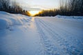 Bright sun at sunset in winter snow-covered road . Royalty Free Stock Photo