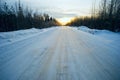 Bright sun sunset in winter snow-covered road . Royalty Free Stock Photo