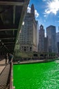 Bright sunbeams over a dyed green Chicago River seen from DuSable Bridge Royalty Free Stock Photo