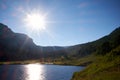 Bright sunburst over a Colorado mountain lake