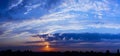 Bright sunlight through the clouds against a breathtaking evening sky at sunset.