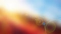 Bright sunlight with lens flare effect over a warm and cool abstract gradient background Royalty Free Stock Photo