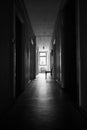 Bright sunlight shines on dark and spooky hallway Royalty Free Stock Photo