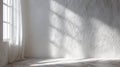 Bright Sunlight Streams Through Window Illuminating Textured White Wall with Shadow Patterns on Floor Royalty Free Stock Photo