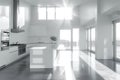 Bright sunlit minimalist kitchen with modern white design Royalty Free Stock Photo