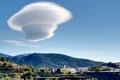 Large lenticular cloud hovers over a hillside Spanish village. Royalty Free Stock Photo