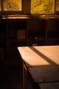 Bright and sunny interior shot of a room with a large window showcasing a wooden table