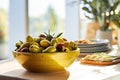 Bright and sunny kitchen scene with bowl of mixed olives, olive oil bottle, healthy eating Royalty Free Stock Photo