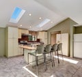 Bright sunny kitchen with vaulted ceiling and skylights.