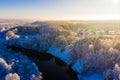 Bright sunny morning begins in winter village, aerial landscape. River curve in rural area. Snowfall concept Royalty Free Stock Photo