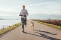 Bright sunny Morning Canicross exercises. Female runs with his beagle dog and happy smiling