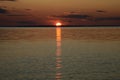 A bright sunny path on the lake, a beautiful sunset and the setting sun. Photo of calm nature