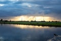 Bright sunrays shine on the high poles of the electricity grid through the village of Nieuwe Wetering