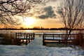 Bright sunrise at the jetty near the lake on a snowy winter morning Royalty Free Stock Photo