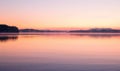 Bright sunrise over the lake, clouds reflected in water surface Royalty Free Stock Photo