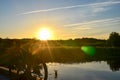 Bright sunrise on the road near the river on the background of a bicycle. Mountain bike in forest with sun rays Royalty Free Stock Photo