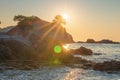 Bright sunrise on sea beach in Lloret de Mar. Sun shine over rocky cliff in Costa Brava beach. Spain coast in morning sunlight Royalty Free Stock Photo