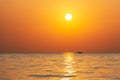 Bright sunset with large yellow sun under the sea surface. Beautiful sunset over the sea. Royalty Free Stock Photo