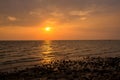 Bright sunset with large yellow sun under the sea surface. sunrise in the sea. Beautiful sunset above the sea. Royalty Free Stock Photo