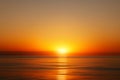 Bright sunset with large yellow sun under the sea surface, Sunrise over sea Royalty Free Stock Photo