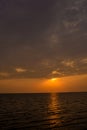 Bright sunset with large yellow sun under the sea surface. sunrise in the sea. Beautiful sunset above the sea. Royalty Free Stock Photo