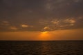 Bright sunset with large yellow sun under the sea surface. sunrise in the sea. Beautiful sunset above the sea. Royalty Free Stock Photo