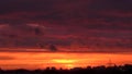 Bright sunset with moving clouds over skyline