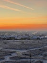 Bright sunset over a snow-covered field and village on a winter evening Royalty Free Stock Photo