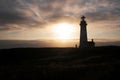 Bright sunset with silhouettes of lighthouse and sharp horizon line