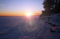 Bright sunset on snowy lake