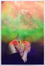 Bright surreal portrait of a girl in colored smoke. Abstract collage on a dark background