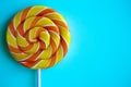 Bright swirl lollipop on blue background with copy space Royalty Free Stock Photo