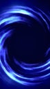 Bright swirling blue vortex of smooth liquid-like light forming a dynamic circular energy motion on dark background Royalty Free Stock Photo