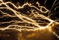 Golden electricity flows dynamically across a dark reflective surface.AI Generated Royalty Free Stock Photo