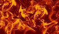 Bright swirling orange flames in motion on a deep red background backdrop. Royalty Free Stock Photo