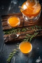 Bright tea with sea buckthorn orange in a glass teapot wooden Board on a dark background