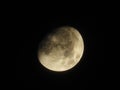 Bright three-quarter moon stands in the night sky Royalty Free Stock Photo