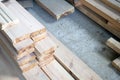Bright timber lying on a concrete floor of a construction warehouse