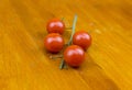 Bright tomatoes on a branch lies on a cutting wooden board