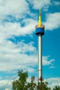 Bright tower against the blue sky with clouds