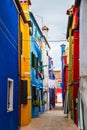 Bright traditional colorful buildings on Burano island, Venice, Italy. Picturesque narrow old street with fabulous