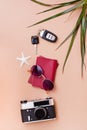 Bright travel flat lay with sunglasses, passports, vintage camera and car keys on a beige background. Car travel. Top and vertical