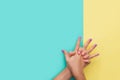 Bright manicure on yellow and mint backgrounds Royalty Free Stock Photo